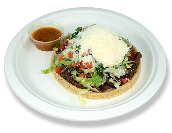 a plate with a sope and a cup of salsa.