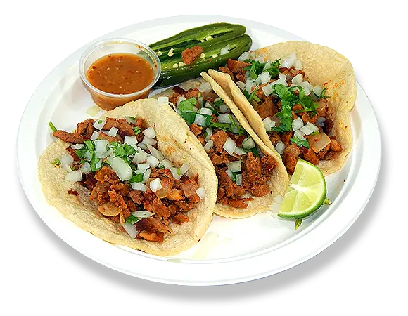  a plate of tacos with a slice of lime, a cup of salsa, and a green pepper. 
