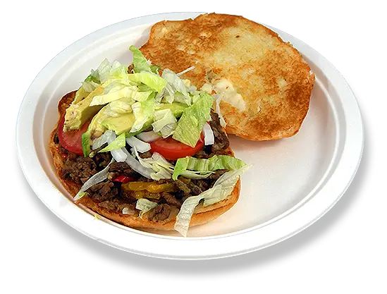 a torta with beef, lettuce, tomato slices, and onion slices.